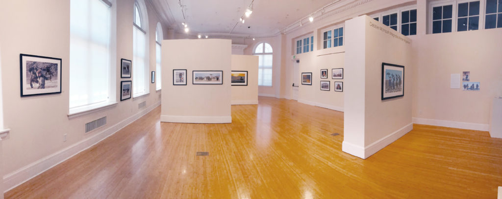 East Oregonian Gallery with color photos on the walls and large expanse of floor. 