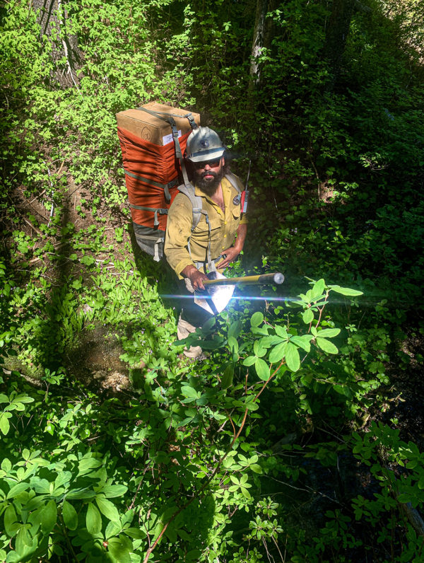 Firefighter hiking with large pack