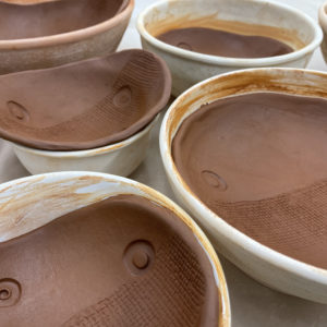 slabs of clay formed with bowl shapes and decorated